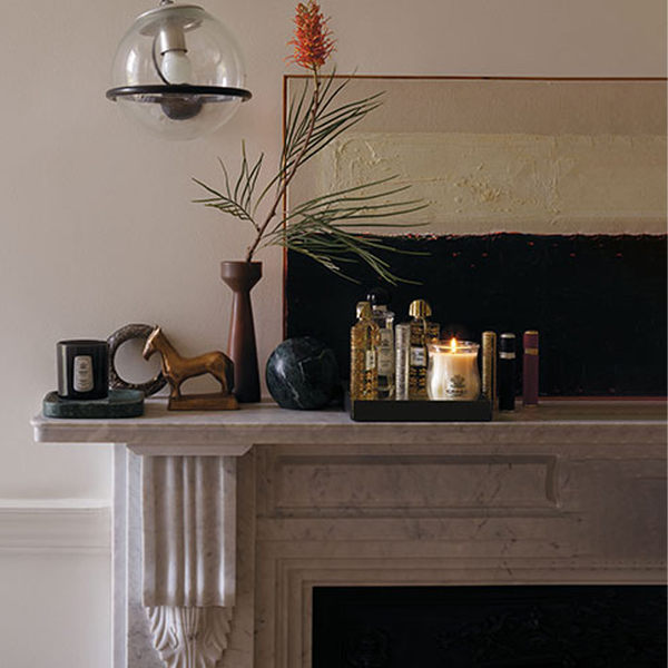 Creed products and ornaments on fireplace