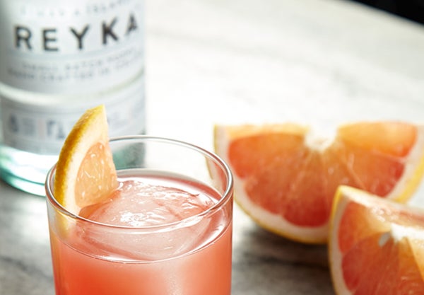 Grapefruit cocktail with a bottle of Reyka