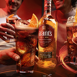 Glasses of run and cola with a bottle of Grant's in the middle