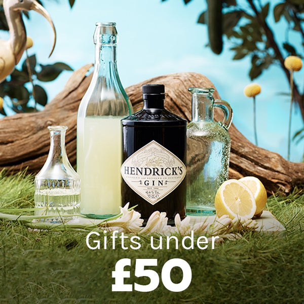 Gifts under £50. Hendricks Gin bottle with lemon juice jugs & lemons.