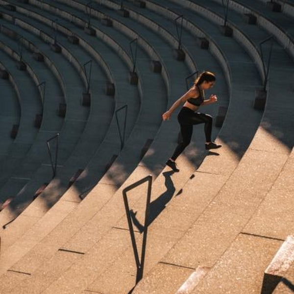 Woman exercising, running up the stairs
