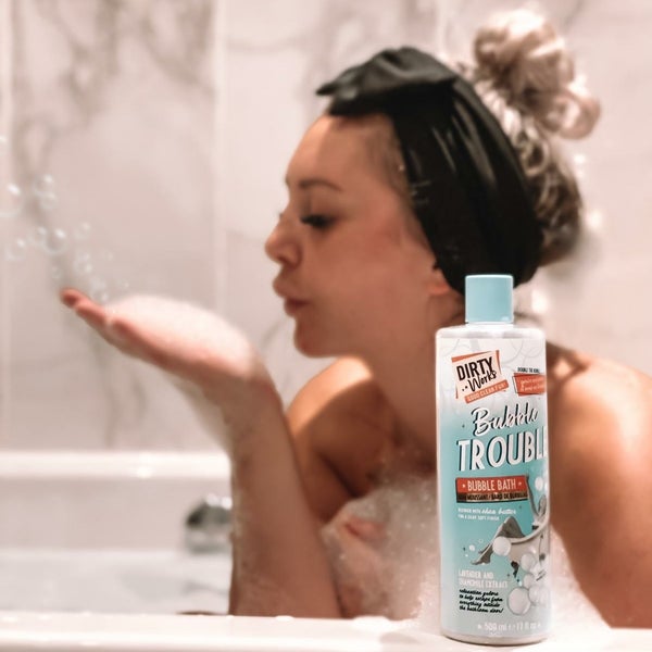 women blowing bubbles in bath tub with dirty works product Visit Our Instagram