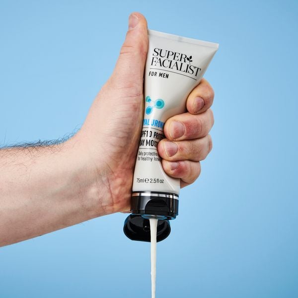hand squeezing cream out of super facialist for men product Visit Our Instagram