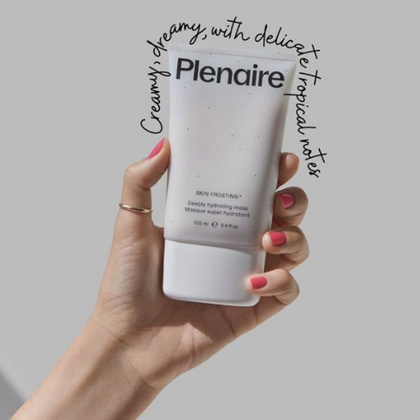 Hand holding Plenaire Skin Frosting Deeply Hydrating Mask with text around creamy, dreamy with delicate tropical notes. Visit our instagram