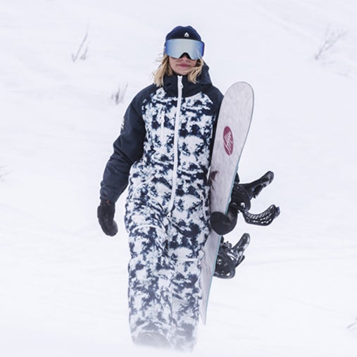 A woman wearing a oneskee snowsuit on the slopes
