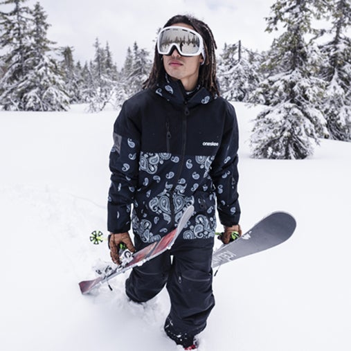 A man wearing a oneskee snowsuit.