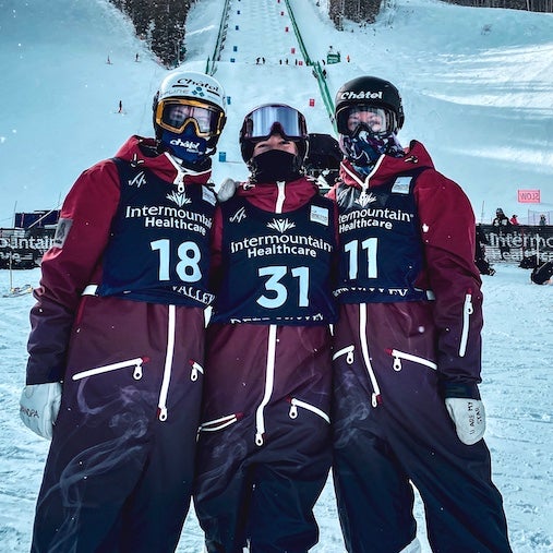 Visit Oneskee Instagram. Professional Skiers at comp, wearing red, white and blue snowsuits specially made by us.