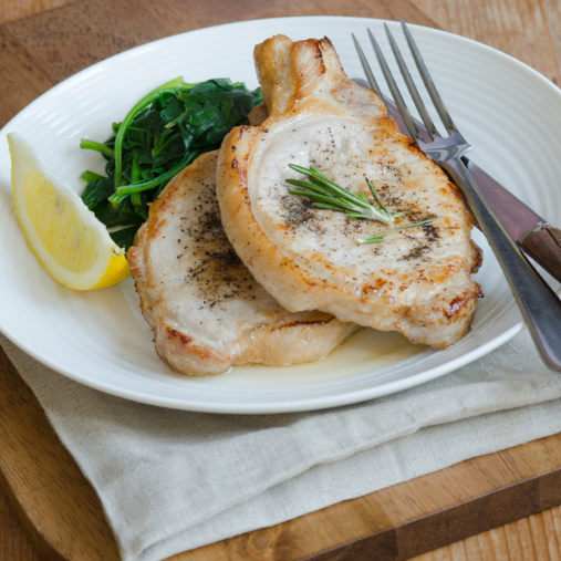An image of Honey and Orange Pork Steaks with Wilted Spinach