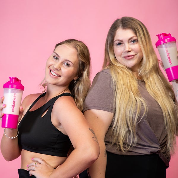 Two women holding Celebrity Slim shakers on a pink background