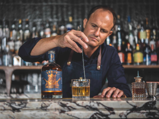 Barman serving Lyre's american malt