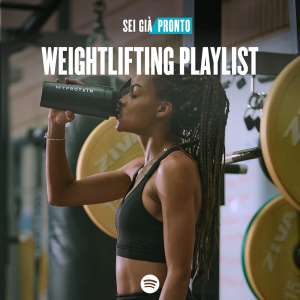 A woman wearing black workout clothes drinking from a black Myprotein shaker with the words 'You're Already Ready - Weightlifting Playlist' overlaying.