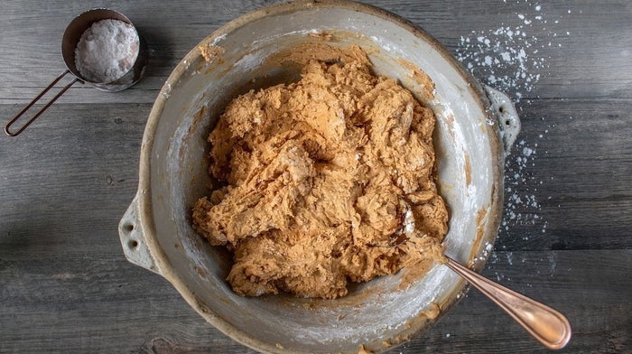 Chocolate and peanut butter cookie batter being mixed in a bowl.