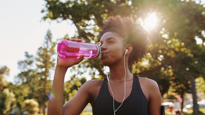 A woman drinks water to support her immune system.