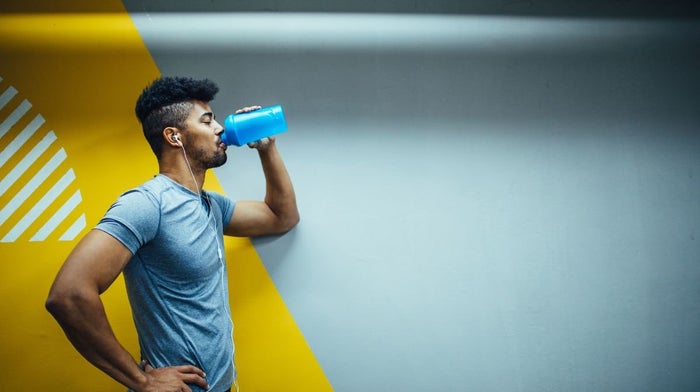 A man drinks pre-workout to support his high-intensity workout.