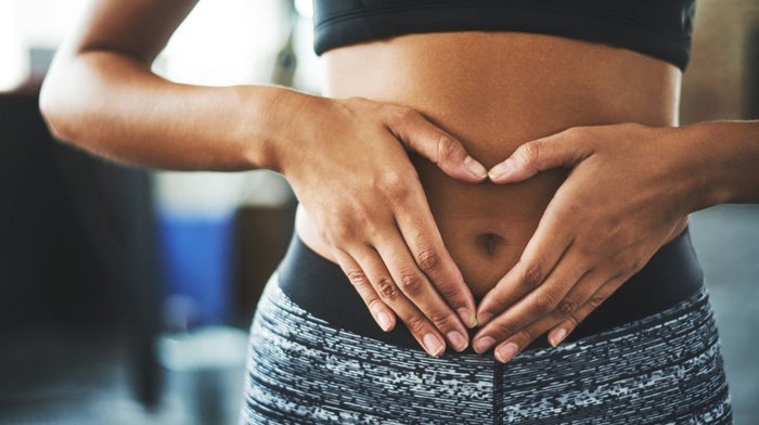 slim woman with hands on her stomach