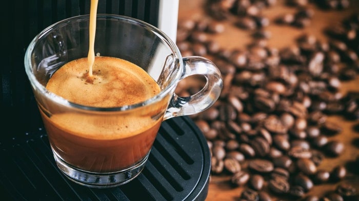 coffee beans next to coffee machine