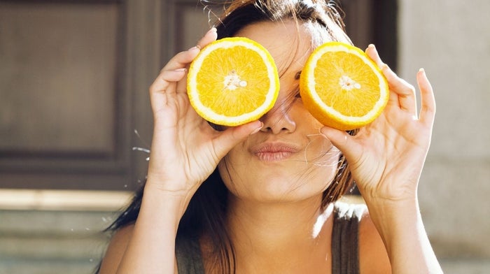 woman holding orange segments