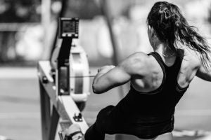 A woman using a rowing machine.