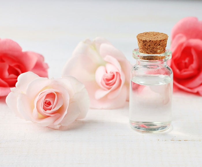 Rose-flowers-and-bottle-of-oil-on-a-white-table-2 | Dermstore Blog