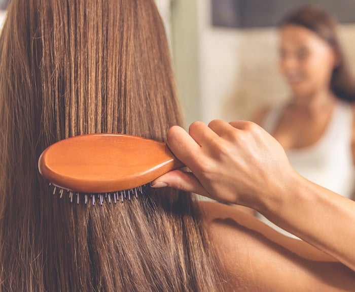 woman brushing her hair