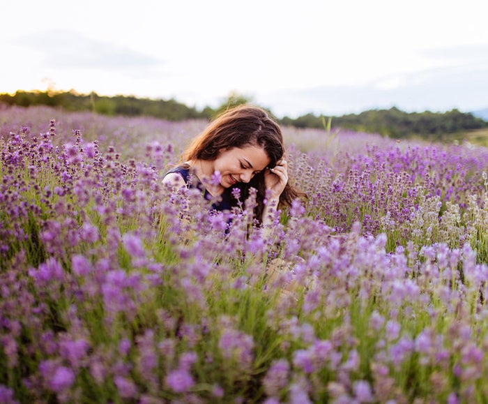 girl sitting in lavender field 2 I Dermstore Blog