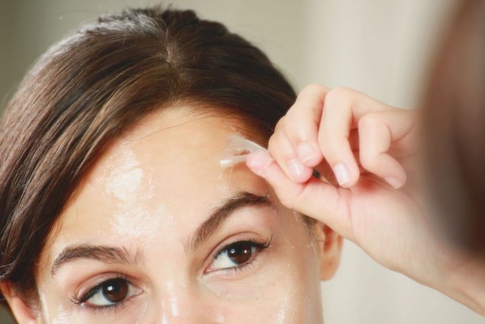 woman removing a facial peel