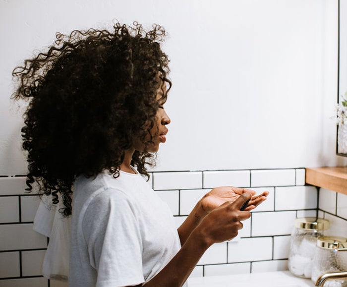 Woman using dermatologist-approved anti-aging products