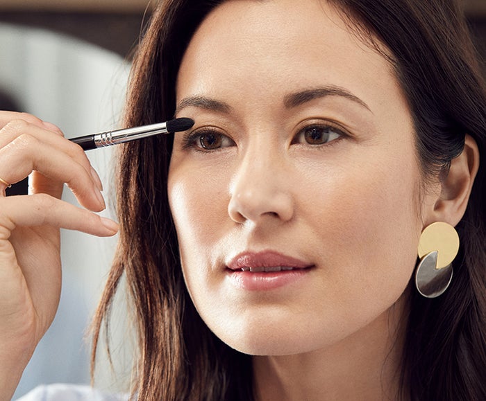 model applying eye makeup I Dermstore Blog