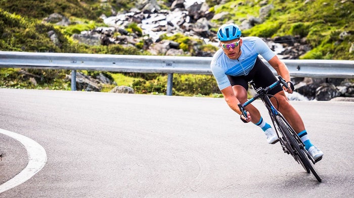 Road cyclist takes corner at pace