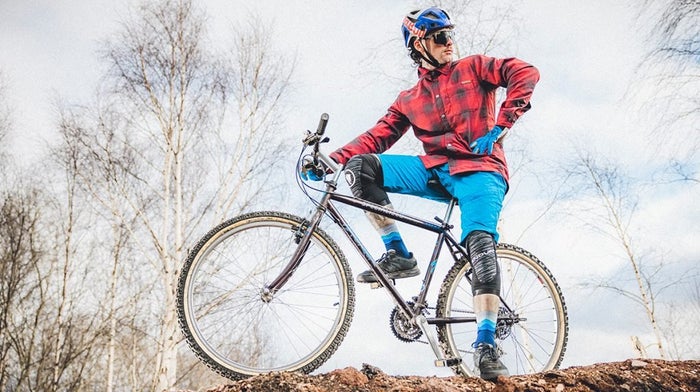 Man poses on top of bicycle