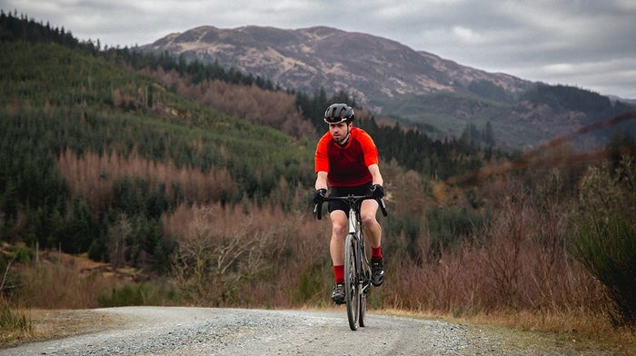 Endura cyclists heads towards camera in red Endura cycling gear