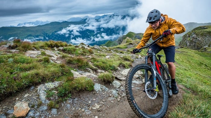 a man on a mountain bike overlooking scenery