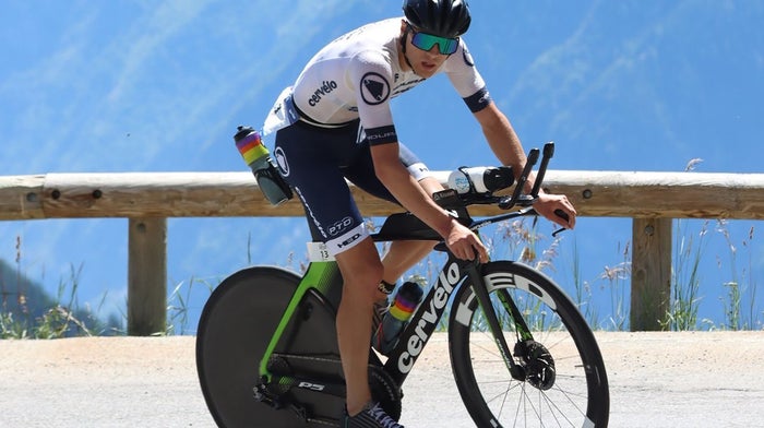 Endura road cyclist takes corner on sunny road