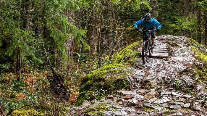 Tom Bradshaw rides along path in Endura waterproof gear