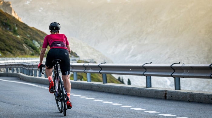 Endura cyclist heads downhill in bibshorts and jersey