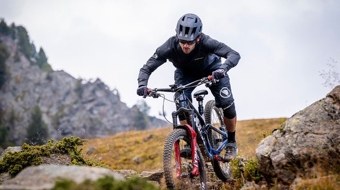 Man in Endura gear with Endura helmet heads downhill