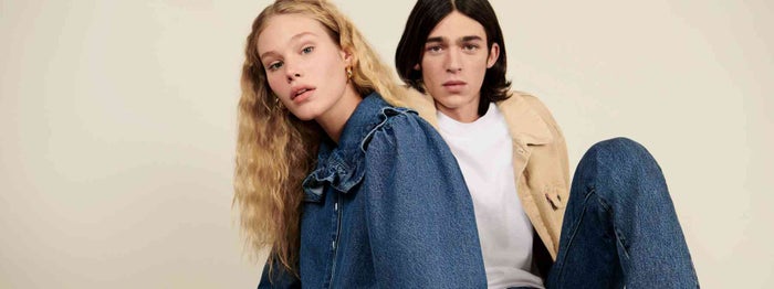 Two people linking arms in Levi denim jackets