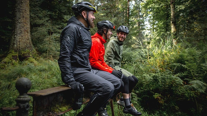 Trio sit on bench in Endura waterproofs