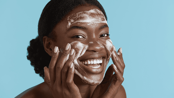 woman cleansing face