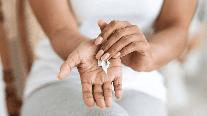 woman applying hand cream   