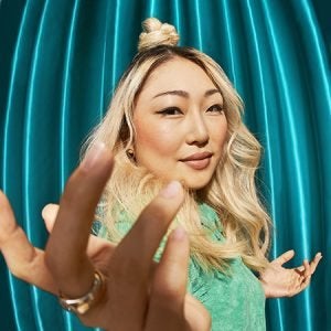 woman with blonde hair with a blue background