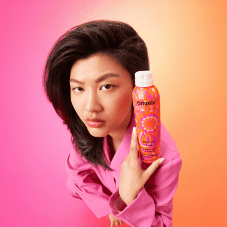 woman with perk up plus dry shampoo