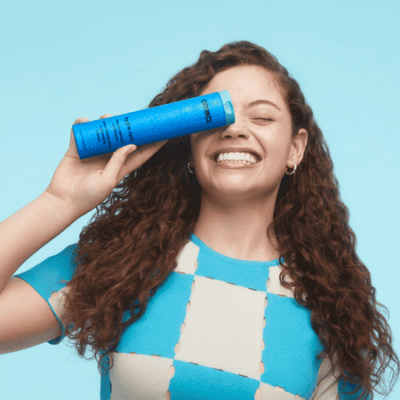 Woman holding intense moisture conditioner