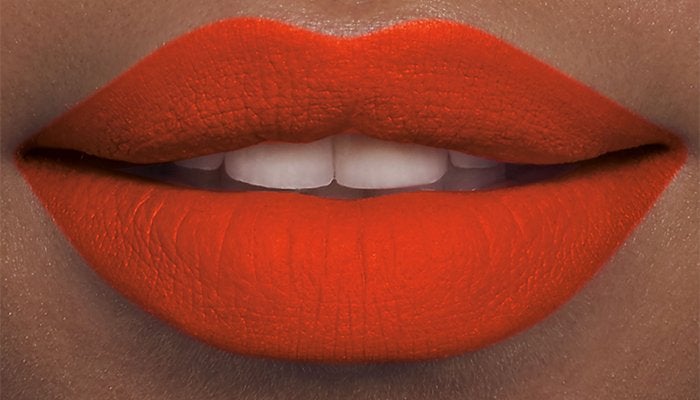 Close up on lips wearing Laura Mercier's Velour Extreme Matte Lipstick