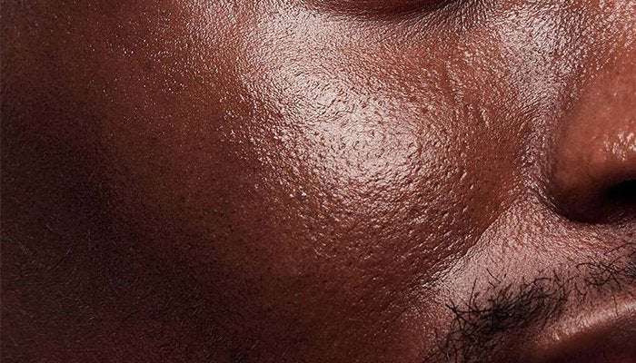 close up of a dark skinned male models cheeks