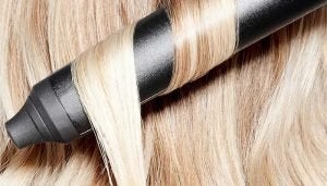 close up of blonde hair being curled using the ghd curler