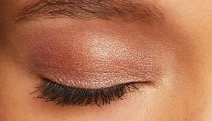 laura mercier caviar eyeshadow on an eyelid in shimmery pink