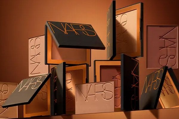 a collection of nars laguna bronzer against a brown background
