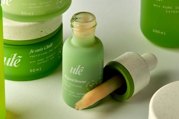 A wide shot of Ulé’s Regard Rescue Eye Reviving Serum and Je suis Chill Fortifying CBD Moisturizer in studio setting.