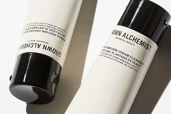 two grown alchemist cleansers shot against a white background in the studio